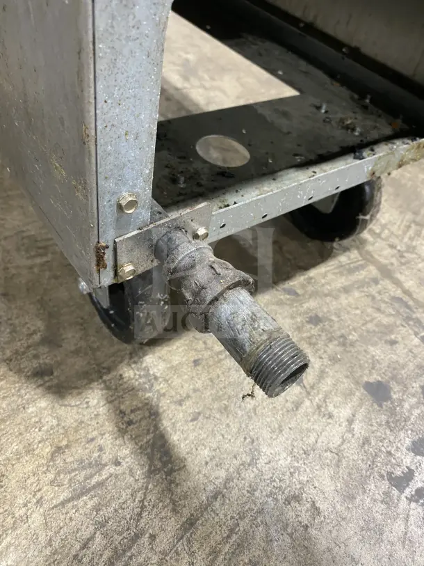 Frymaster commercial gas deep fat fryer corner view with caster wheels and gas connection, showing wear and surface rust.