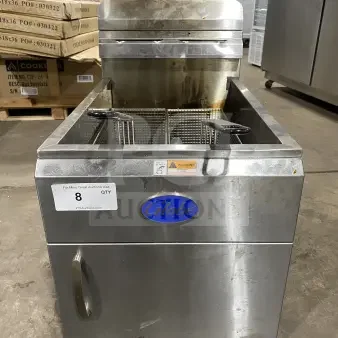 Commercial countertop deep fat fryer by Globe, model GF30G, stainless steel, natural gas powered, with fry baskets, back splash, and basket hanger.