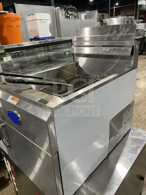 Stainless steel Globe GF30G natural gas countertop fryer, 2023 model, with backsplash, basket hanger, and fry baskets.