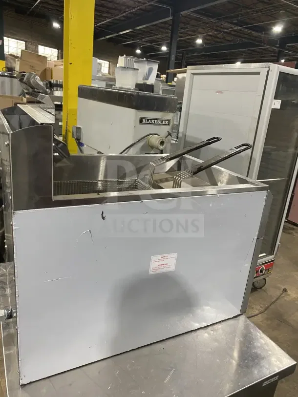 Globe GF30G stainless steel natural gas countertop deep fat fryer with back splash, basket hanger, and fry baskets, in good condition.