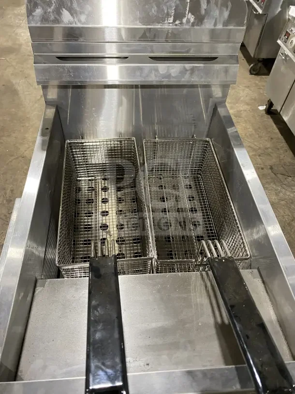 Stainless steel Globe GF30G countertop deep fat fryer with baskets, backsplash, basket hanger, and serial number 1523085399.