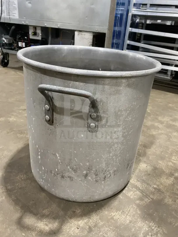 Heavy-duty aluminum stock pot with handles, used condition, ideal for commercial use as a mixing vessel.