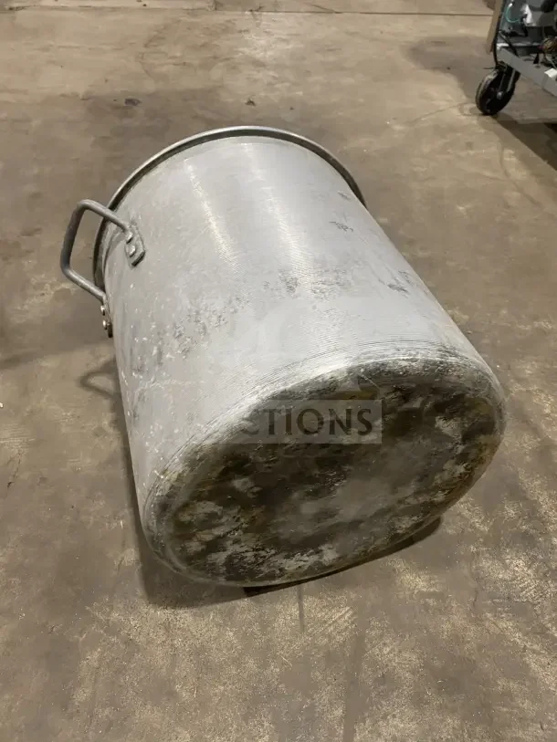 Commercial heavy-duty aluminum stock pot or mixing vessel with handles. Visible wear and patina on surface.