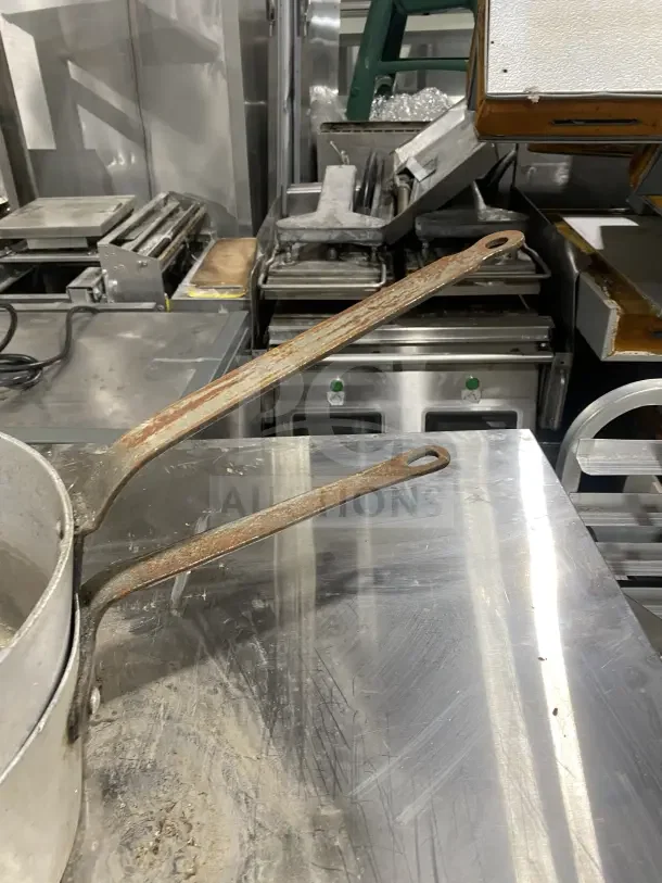 L&G commercial aluminum tapered sauce pans with heavy-duty riveted handles, shows usage wear.