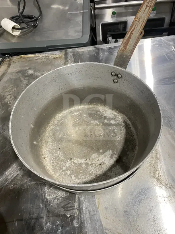 L&G Commercial Aluminum Tapered Sauce Pan, heavy-duty handle, visibly used, with signs of wear and patina.