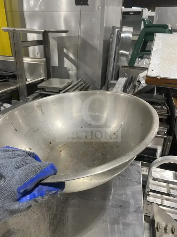 Commercial stainless steel mixing bowl in used condition, visible wear. Ideal for heavy-duty kitchen use.