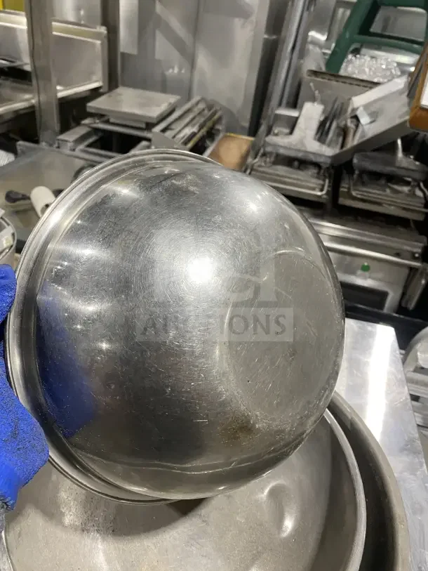 Commercial stainless steel mixing bowls, durable and high-capacity. Some surface scratches, ideal for professional kitchens.