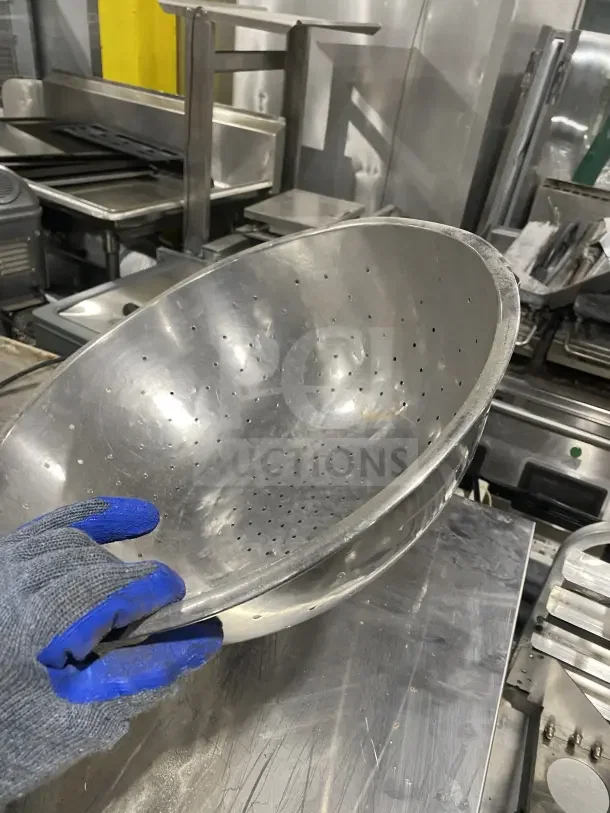 Commercial stainless steel colander, used condition, perforated design for efficient draining, heavy-duty kitchenware.