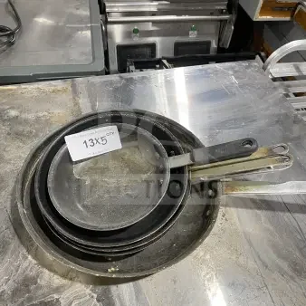 Commercial stainless steel non-stick frying pans with heavy-duty handles. Includes multiple sizes. Condition: Used. Label reads "13X5 QTY."