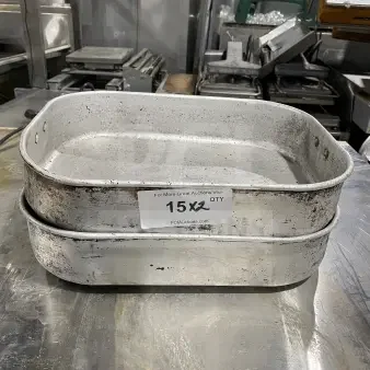 Commercial aluminum roasting/baking pans with handles, auction label "15X2", used condition, visible wear.