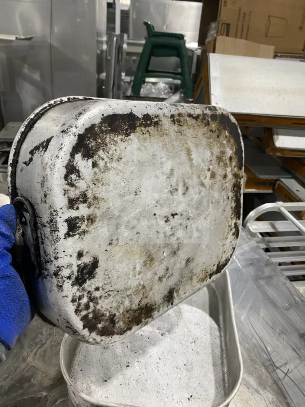 Commercial aluminum roasting/baking pans with handles, showing signs of wear. Auction bid is doubled upon purchase.