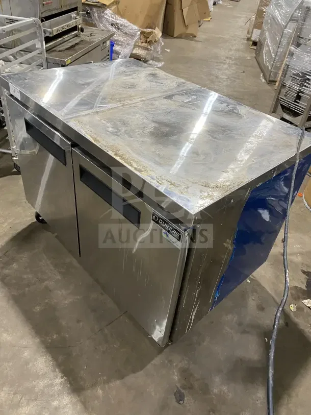 Dukers DUC48F 2-door refrigerated lowboy/worktop freezer, solid stainless steel, on casters, includes poly-coated rack.