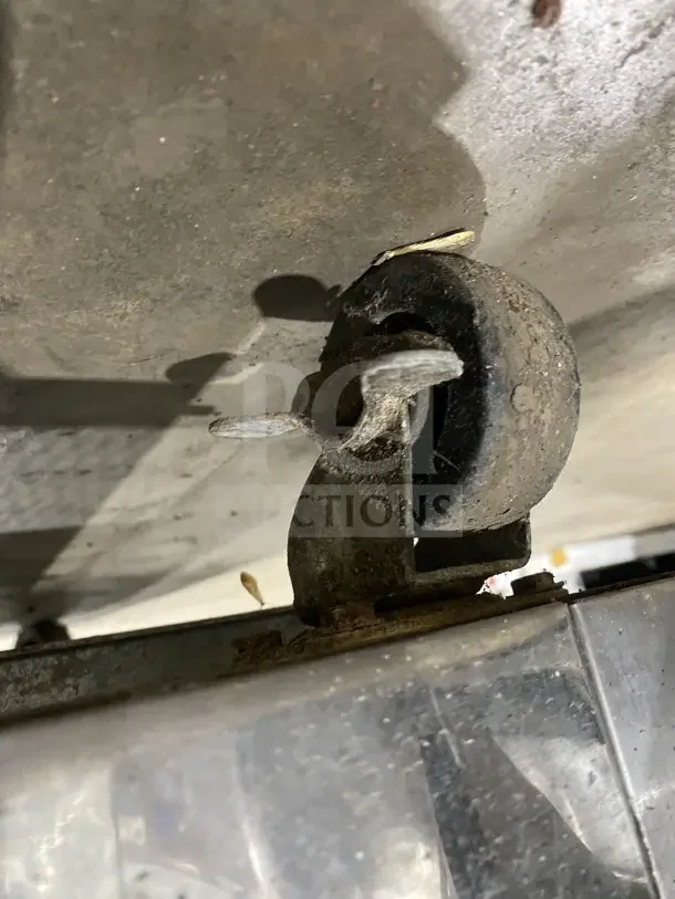 Close-up of a caster on a Supera 2-Door Refrigerated Pizza Prep Table, model PS61MTHC. Visible wear and rust.