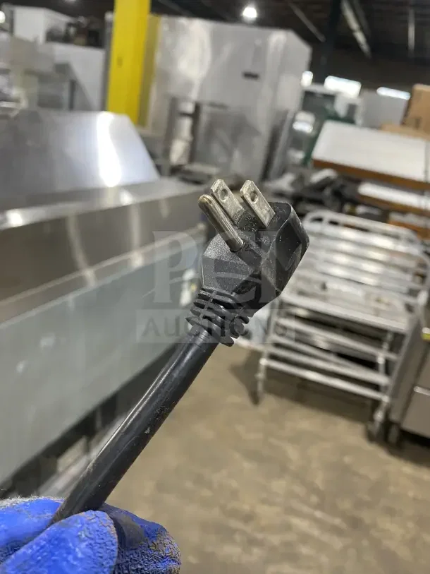 Power cord of a Supera Commercial 2-Door Refrigerated Pizza Prep Table, Model PS61MTHC, shown in an industrial setting.