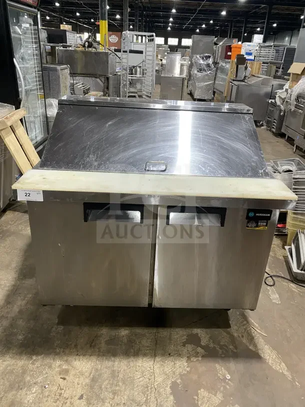 Commercial stainless steel 2-door refrigerated prep station, model HKN-SPMT48R2E, with cutting board and casters.
