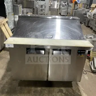Commercial stainless steel 2-door refrigerated prep station, model HKN-SPMT48R2E, with cutting board and casters.