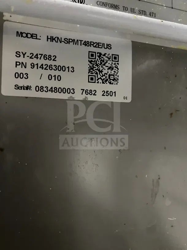 Commercial stainless steel 2-door refrigerated prep station with cutting board, model HKN-SPMT48R2E, on casters. Appears used with visible wear.