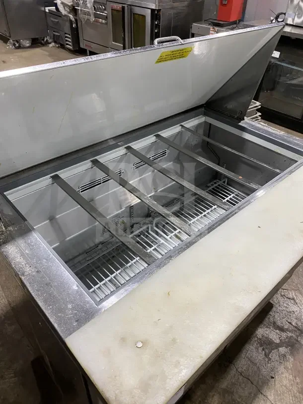 Commercial stainless steel 2-door refrigerated prep table, model HKN SPMT48R2E, with cutting board on casters.