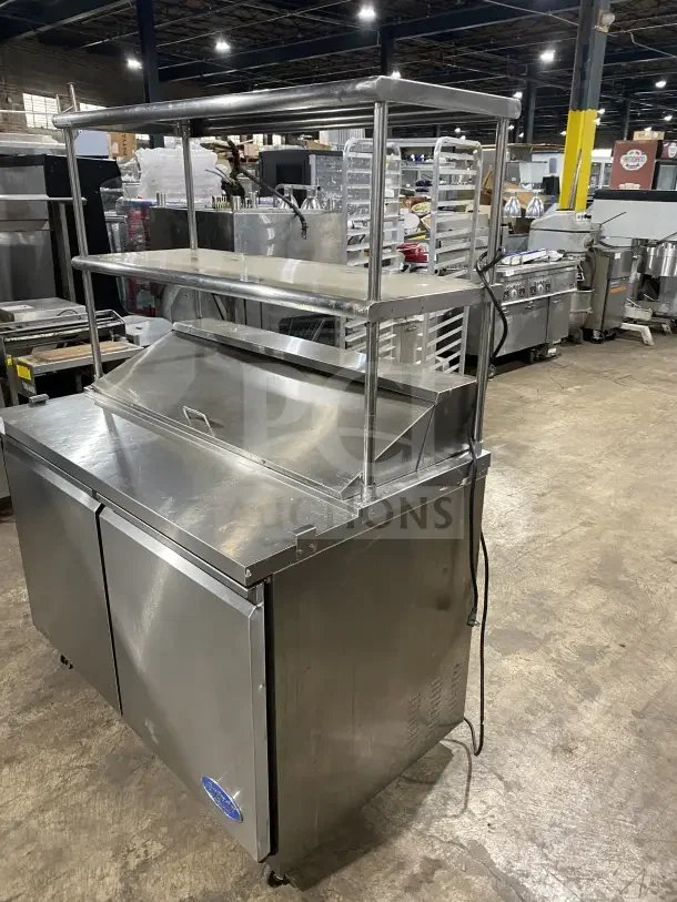 Entree S48 commercial stainless steel refrigerated prep table with double overhead shelf, on casters. Model: S48, SN: 1107CONH01175.