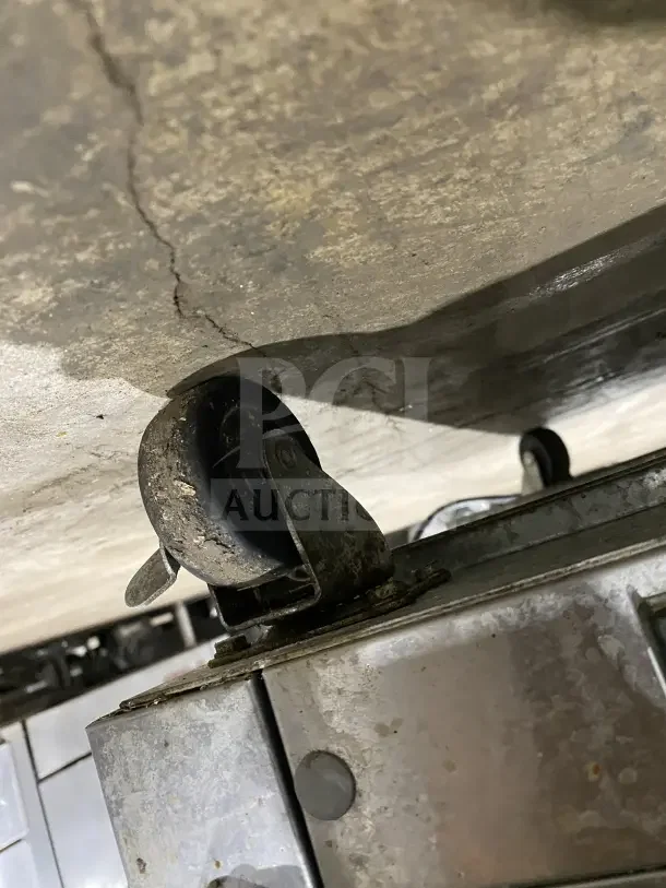 Entree S48 refrigerated prep table caster detail, showing stainless steel construction and mobile design. Good condition.