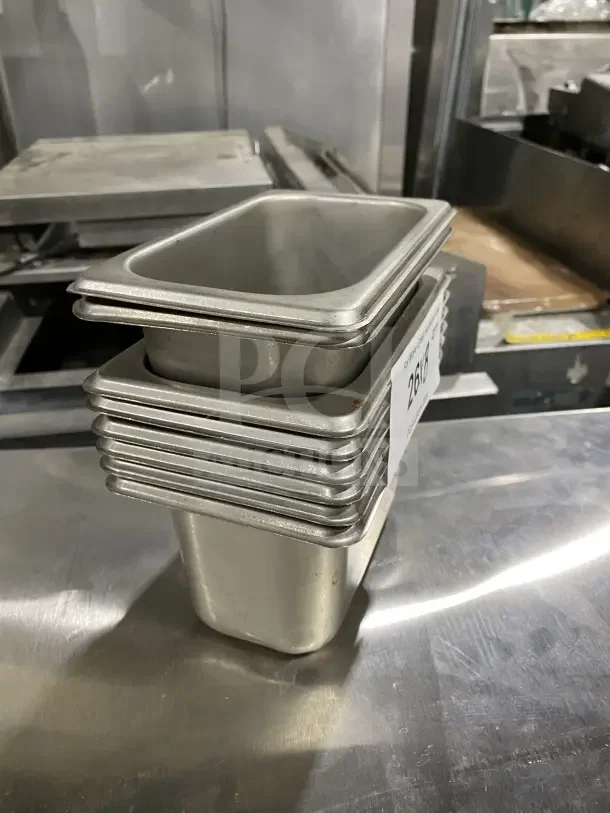 Winco stainless steel trays, stacked, for salad or sauce, commercial use. Visible tag indicates auction lot number 26.