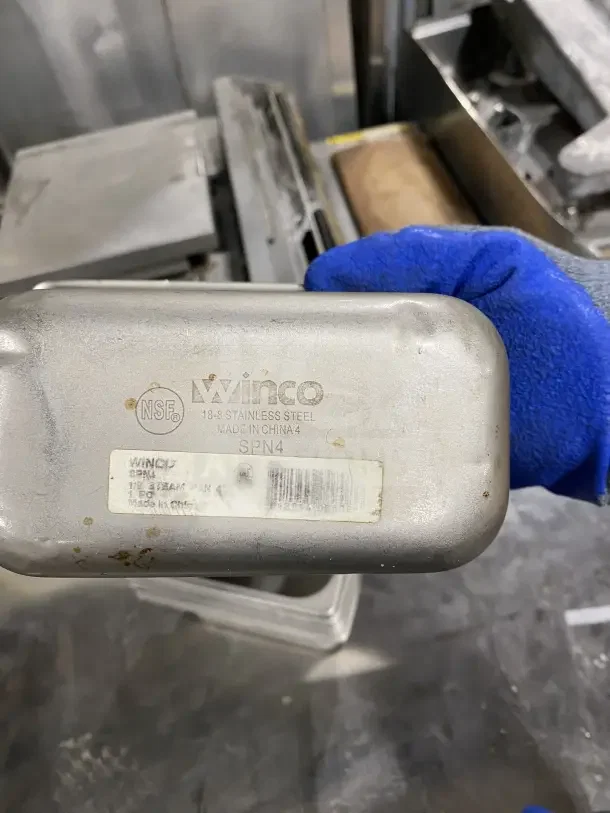 Winco stainless steel tray, commercial-grade, model SPN4, 18-8 steel, visible labels, slight wear, ideal for salads or sauces.