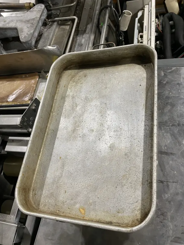 Commercial stainless steel baking tray, used condition, rectangular shape, durable construction, ideal for high-volume baking.
