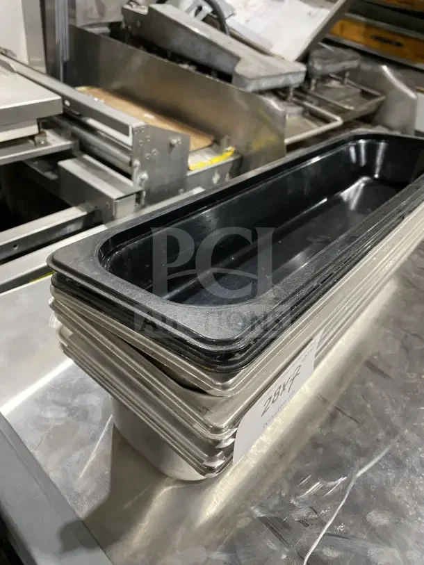 Stack of commercial stainless steel trays, ideal for cinnamon rolls or salad prep, in good condition; 7x your bid offer.