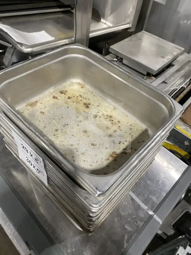 Commercial stainless steel sauce/salad prep tray, well-used condition, stackable, visible wear and markings, 20x30 label shown.