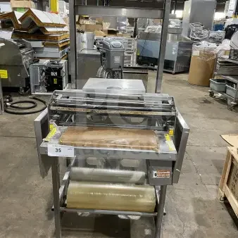 Good Nature commercial stainless steel wrapping station with casters. Used condition, equipped with packaging rolls.