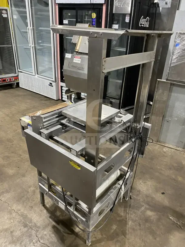 Good Nature commercial stainless steel floor-model wrapping station with casters. Features sturdy construction. Visible label.
