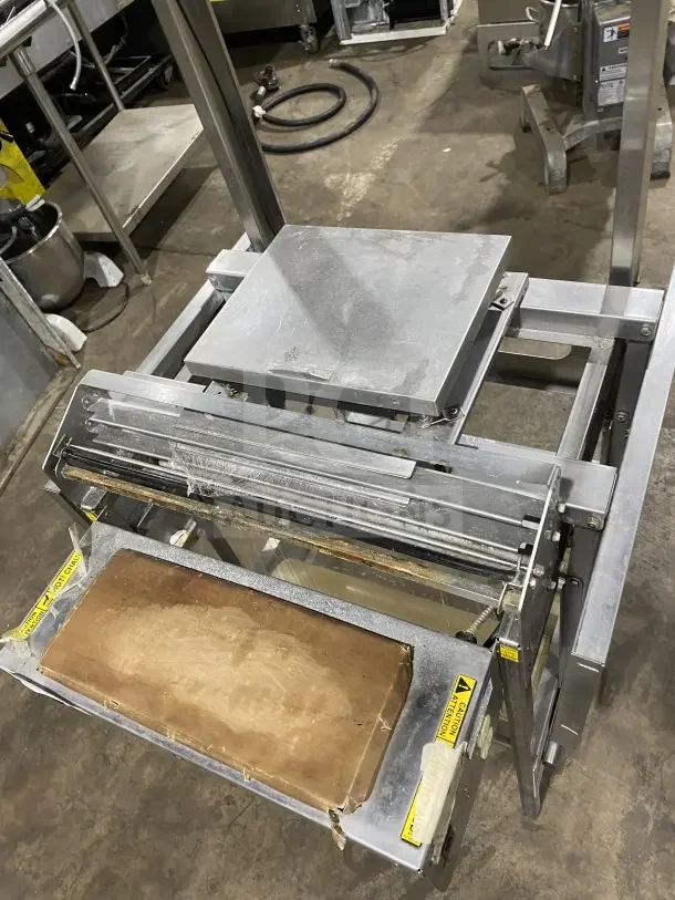 Good Nature commercial stainless steel floor-model wrapping station on casters, featuring a sturdy design.