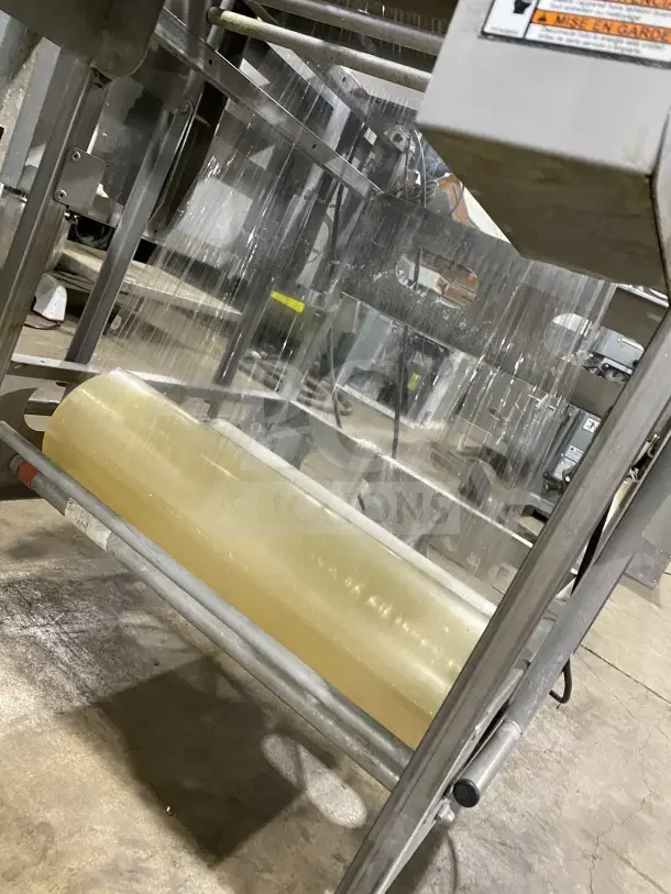 Good Nature stainless steel floor-model wrapping station on casters. Equipped with a large plastic wrap roll.