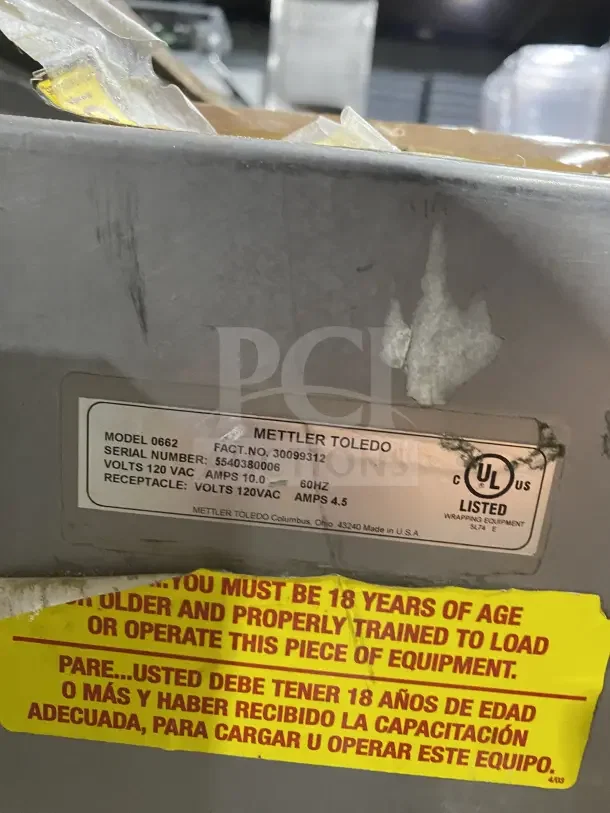 Good Nature stainless steel wrapping station on casters. Label: Mettler Toledo model 0662, 120VAC, 10.0 Amps.