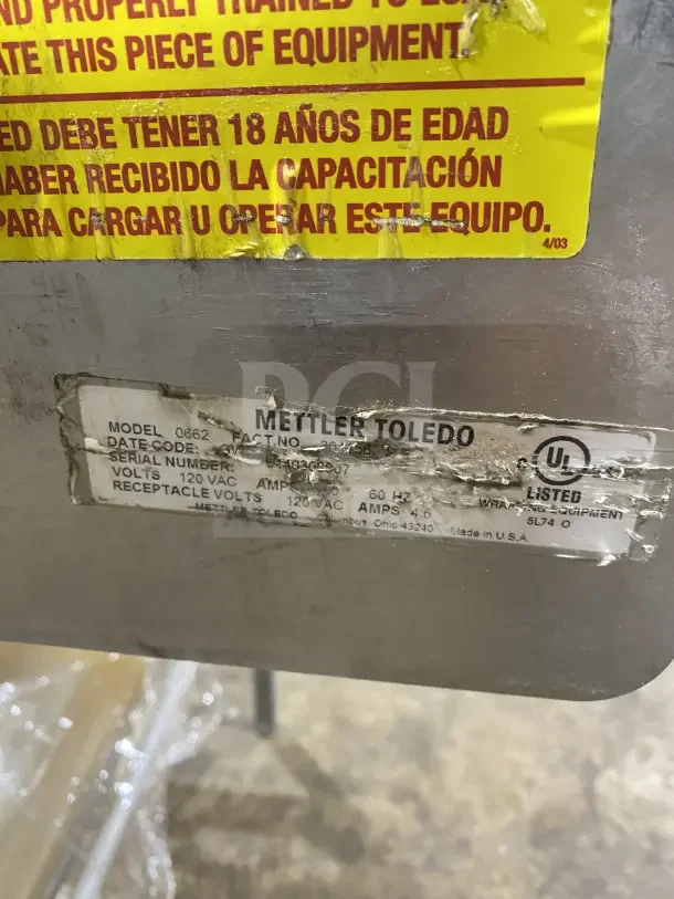 Commercial stainless steel wrapping station, model 0662, 120V, on casters, Mettler Toledo label, visible wear.