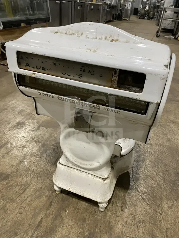 Dayton Commercial white porcelain countertop computing scale, vintage, visible wear, labeled "CUSTOMERREAD SCALE."