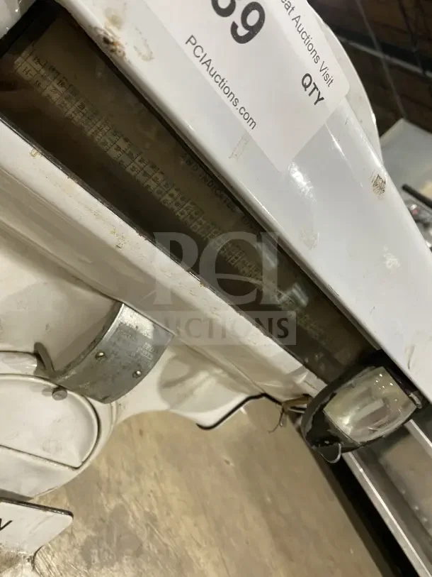 Dayton commercial porcelain computing scale, white, used condition, visible wear. Auction label and dial indicators present.