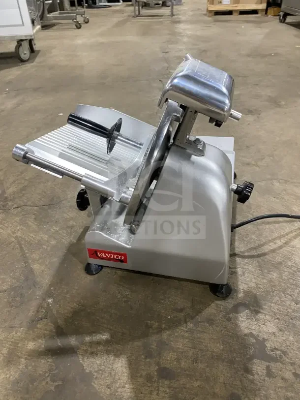 Avantco 250ES10 heavy-duty semi-automatic meat slicer, 10-inch stainless steel blade, excellent condition, on legs.