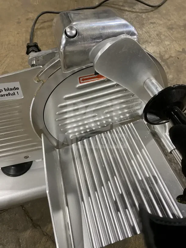 Avantco 250ES10 commercial meat slicer, 10-inch blade, stainless steel, semi-automatic, model 250ES10, used condition.