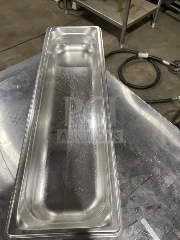 Commercial stainless steel full-size hotel pan, lightly used, shows surface marks, ideal for catering or kitchen use.