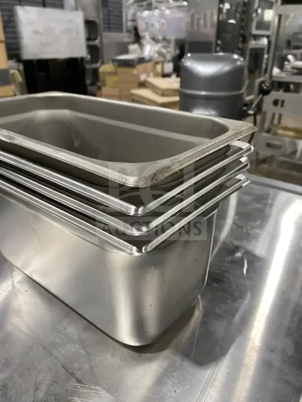 Winco Commercial Stainless Steel Half-Size Hotel Pans, Model SPJL306, stacked, reflective surface, used condition.