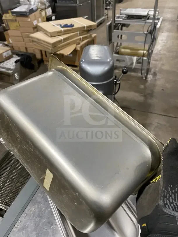 Winco SPJL306 stainless steel half-size hotel pan, gently used, with minor scratches. Durable build for commercial use.