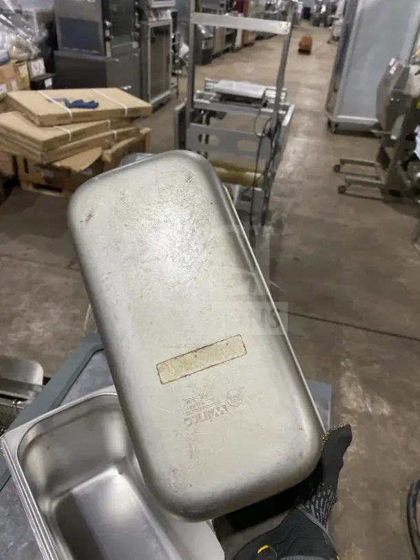 Winco SPJL306 stainless steel half-size hotel pan, used condition, features visible brand marking, and durable design.