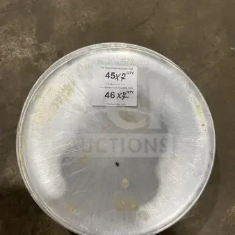 Commercial round aluminum pizza pan with visible wear, marked for auction. Includes label showing quantities available.