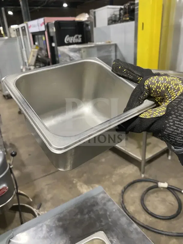 Commercial stainless steel sixth-size food pan in good condition, ideal for catering events, 13x your bid potential.