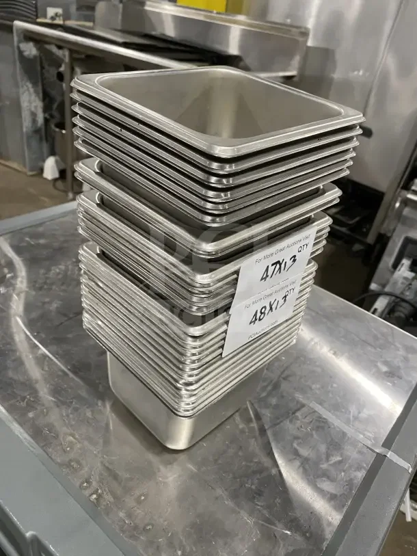 Stack of commercial stainless steel sixth-size food pans, excellent condition, labeled "48x/13 QTY" for auction.