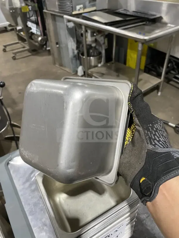 Commercial stainless steel sixth-size food pan, gently used. No visible dents or scratches, ideal for kitchen use.