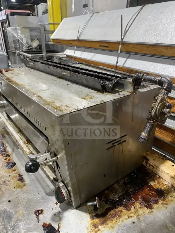 American Range commercial stainless steel salamander broiler, used condition, featuring manual controls and adjustable grates.