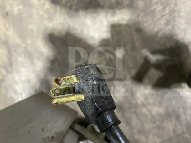Plug with tarnished prongs on Commercial Stainless Steel 2-Drawer Heavy-Duty Refrigerated Chef Base. Condition shows signs of use.