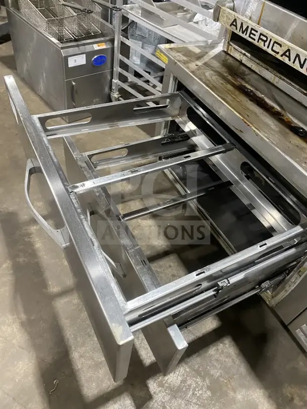 Commercial stainless steel 2-drawer refrigerated chef base, heavy-duty, on casters, shown with open drawers.